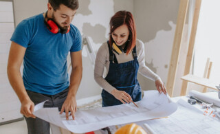 couple looking at blueprint of home