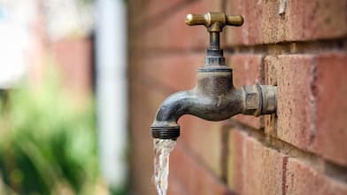 closeup of outdoor faucet against brick wall