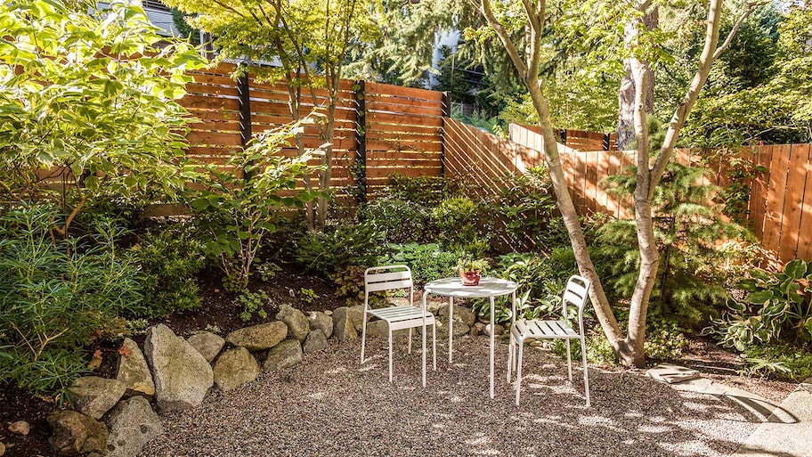 Fenced backyard with table and chairs