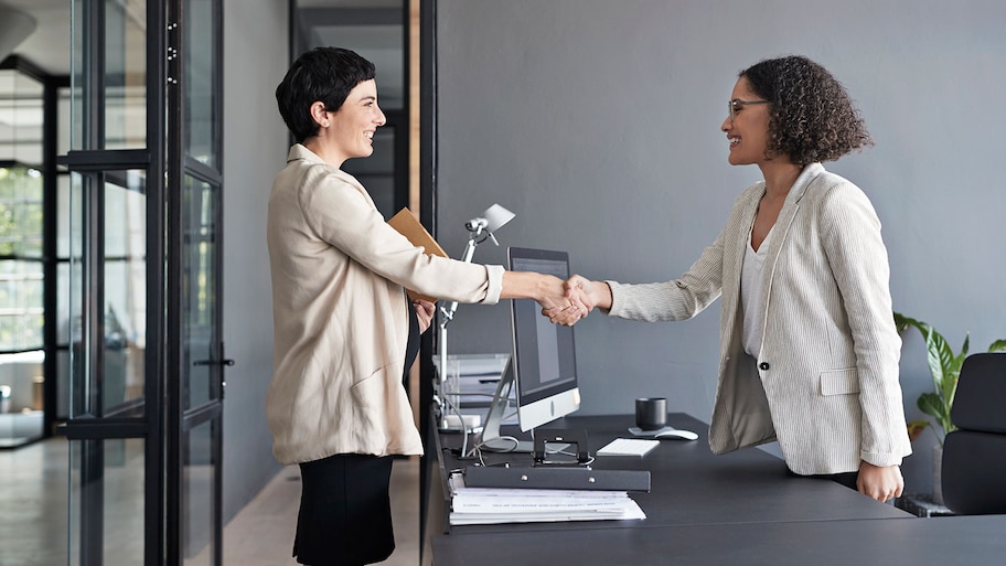 Businesswomen closing a deal at the office