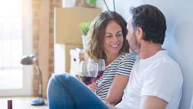 A couple drinking wine after moving in in their new house