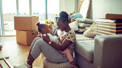 Mother playing with child while packing