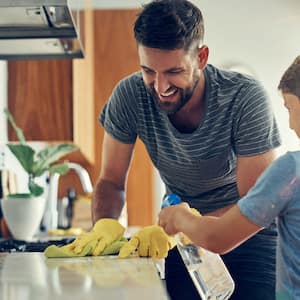 Father and son clean countertops