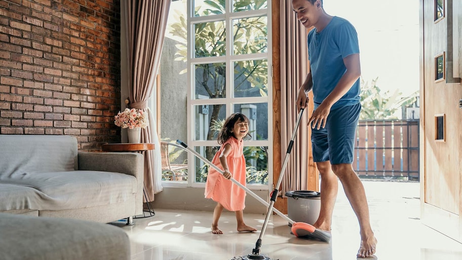 Girl doing chores with dad