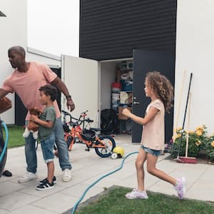 A family loading luggage in their car while charging it