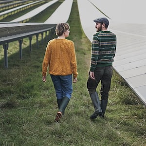 Farmers walking through solar farm