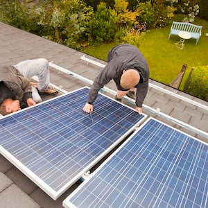 Men repairing a solar panel