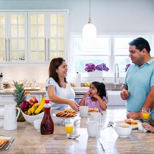 Family enjoys preparing breakfast in kitchen