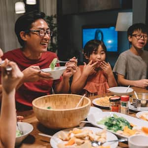 A family enjoying the dinner in their house