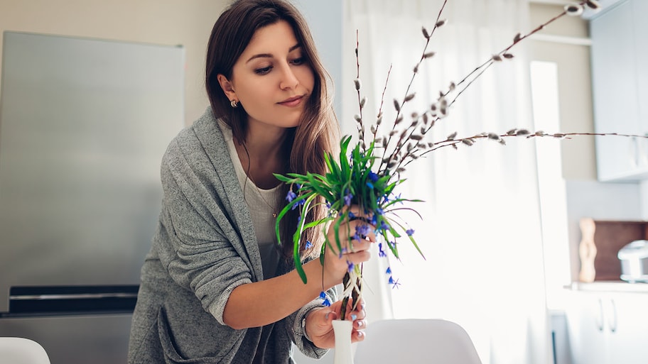 woman putting flowers in a vase