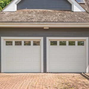 grey house with white garage doors 