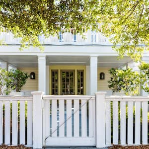 white wooden gate in front of white two-story house