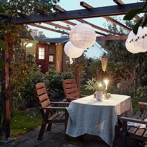 A patio table set for dinner at dusk