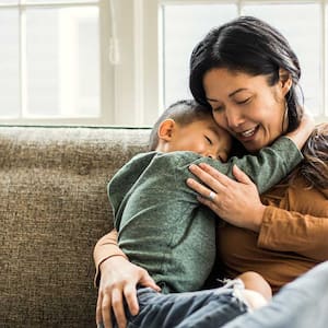 Mother and son hugging at home