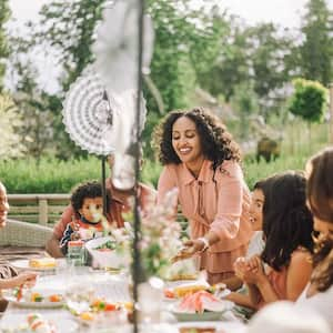 A family eats in a backyard