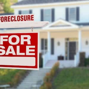 A foreclosure home for sale sign
