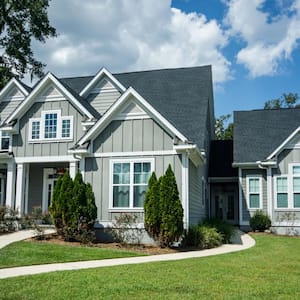 A house with hardy board siding on a large lot with a green lawn