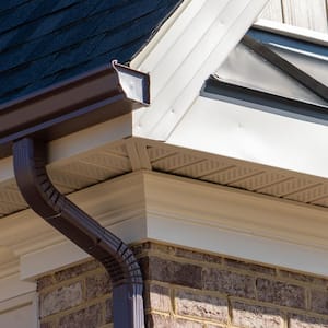 A dark brown gutter system including a downspout