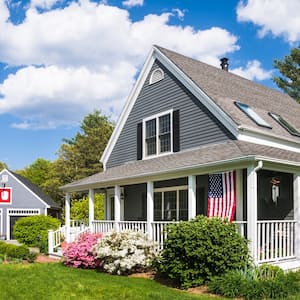 Two-story house with landscaping and garage.