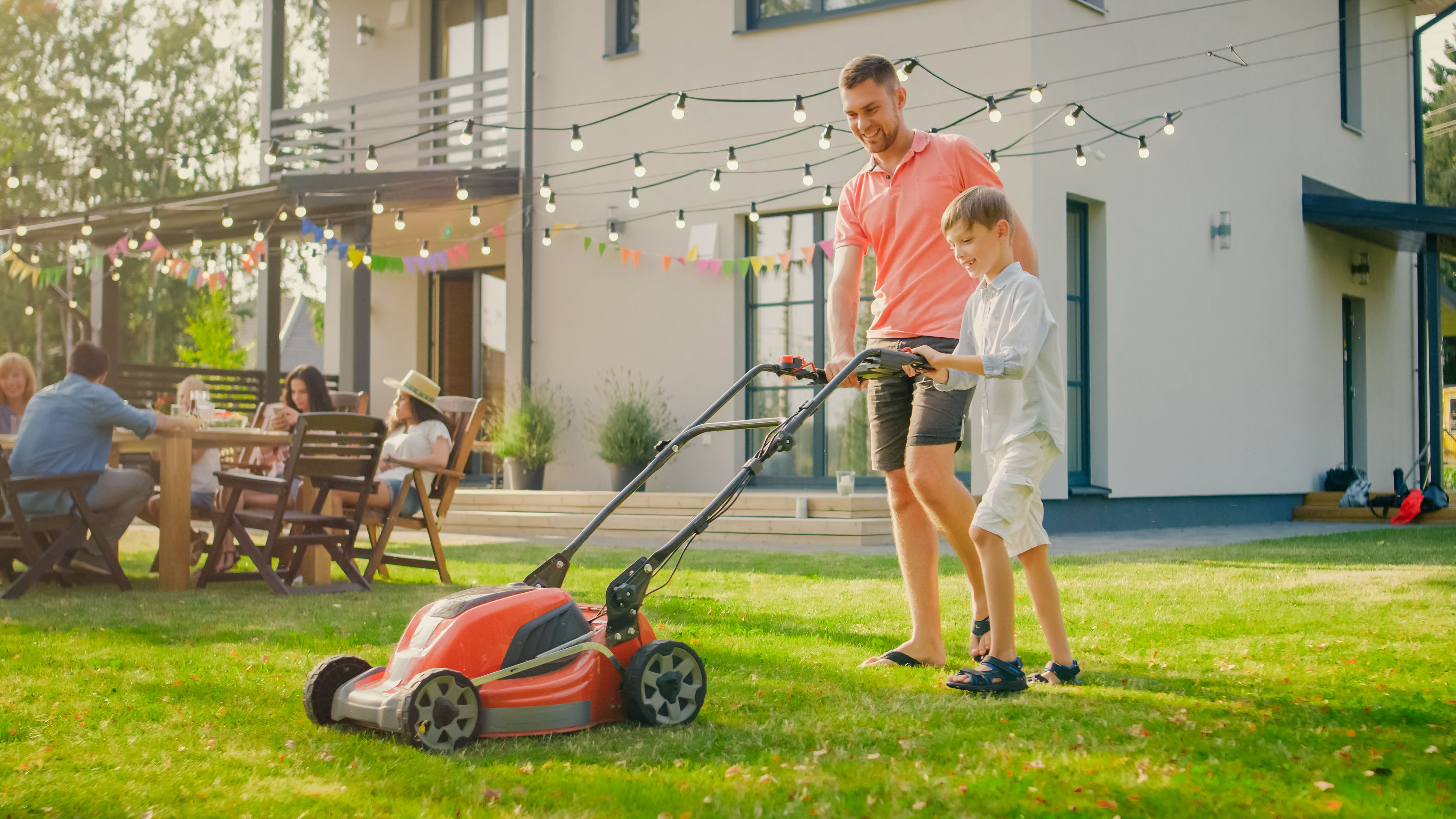 Father and son mowing the lawn