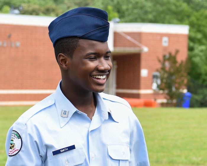 Young high school student smiles at camera