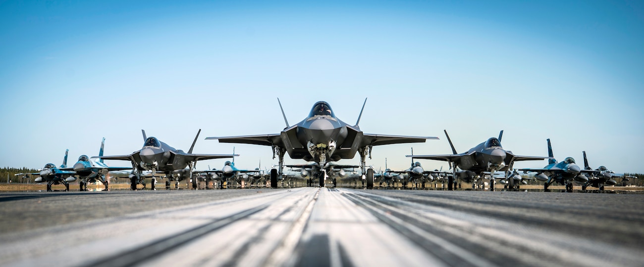 A formation of F-35A Lightning IIs and F-16 Fighting Falcons assigned to the 354th Fighter Wing assemble