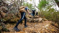 Marines in civilian clothes hiking in mountains.