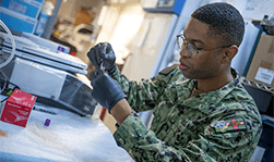 U.S. Navy Hospital Corpsman test samples for malaria