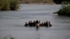 FILE - Migrants, mostly from Nicaragua, cross the Rio Grande into the U.S., at Eagle Pass, Texas, May 20, 2022. 