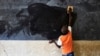 FILE - A young boy cleans the blackboard at a school in Segou, Mali, Oct 1, 2019. A United Nations study says 222 million students worldwide have had their education disrupted by recent crises.