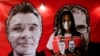 A demonstrator holds a sign with images of British journalist Dom Phillips and indigenous expert Bruno Pereira, during a protest against Brazilian President Jair Bolsonaro's government in Brasilia, Brazil June 15, 2022. 