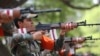 FILE - Indian army women recruits demonstrate their shooting skills as part of their training during a media visit in Bengaluru, March 31, 2021. 