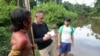 FILE - Veteran foreign correspondent Dom Phillips talks to two Indigenous men in Aldeia Maloca Papiú, Roraima state, Brazil, Nov. 16, 2019