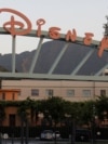 FILE - A portion of the signage at the main gate of The Walt Disney Co. is pictured in Burbank, California May 7, 2012.