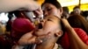 FILE - A child receives a polio vaccine during a government-led vaccination program in Quezon City, Philippines, Oct. 14, 2019. The UK Health Security Agency is urging parents to make sure their children are vaccinated after polio was detected in sewage samples in London in 2022.