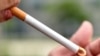 A woman lights a cigarette in a park in Brussels, May 7, 2017. The U.S. Food and Drug Administration is proposing to limit the amount of nicotine allowed in cigarettes with an aim toward making it easier for users to quit using them and prevent young people from getting addicted.