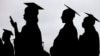 FILE - New graduates line up before the start of the Bergen Community College commencement at MetLife Stadium in East Rutherford, New Jersey, May 17, 2018.