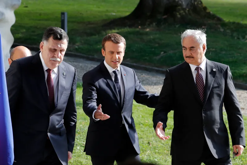 Left to right: Libyan Prime Minister Fayez al-Sarraj, French President Emmanuel Macron, and Marshal Khalifa Haftar near Paris, July 2017.