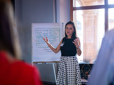 Sofia presents in front of a flip chart