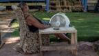 Yvette Johnson, 54, sits next to a fan outside of her families home on June 10, 2022 in Houston, Texas