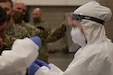 A Utah National Guard Mobile Testing Team member conducts a nasopharyngeal sample collection on a Soldier in Salt Lake City to test if they are a carrier of the novel coronavirus, COVID-19, May 27, 2020. To collect a sample a flocked swab is sent through the nasal cavity and will stay there for 20 seconds, be twisted and removed.