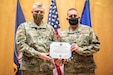 Tech. Sgt. Erik Bornemeier, a medical technician assigned to the 151st Medical Group, Detachment 1, receives the Utah Cross from The Adjutant General of the Utah National Guard Maj. Gen. Michael J. Turley on March 15, 2021 at Roland R. Wright Air National Guard Base, Utah. The Utah Cross is the second highest state award that an Utah National Guard military member can receive. (U.S. Air National Guard photo by Tech. Sgt. Colton Elliott)