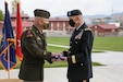 Maj. Gen. Michael J. Turley, adjutant general of the Utah National Guard, presents Brig. Gen. Thomas C. Fisher, the former commander of the Utah Army Guard Land Component Command, with a flag during his retirement ceremony on Camp Williams, Utah, May 1, 2021. Turley remarked that Fisher was truly a teacher of Soldiers and never forgot about how important each individual Soldier is to the units. (U.S. Army National Guard photo taken by Spc. Alejandro Lucero)