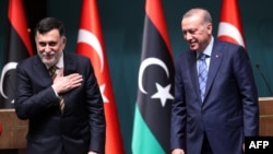 Turkish President Recep Tayyip Erdogan, right, and Libyan Prime Minister Fayez al-Sarraj hold a joint press conference at the Presidential Complex in Ankara on June 4, 2020.