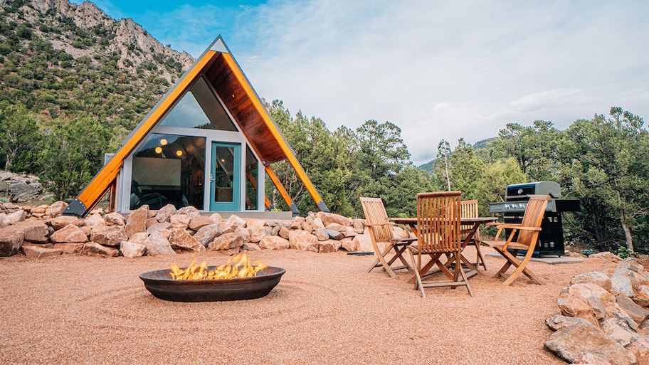 fire pit in front of A frame home