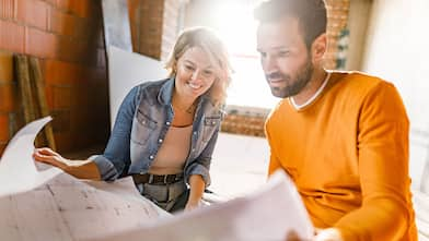 couple looking over blueprints for garage conversion