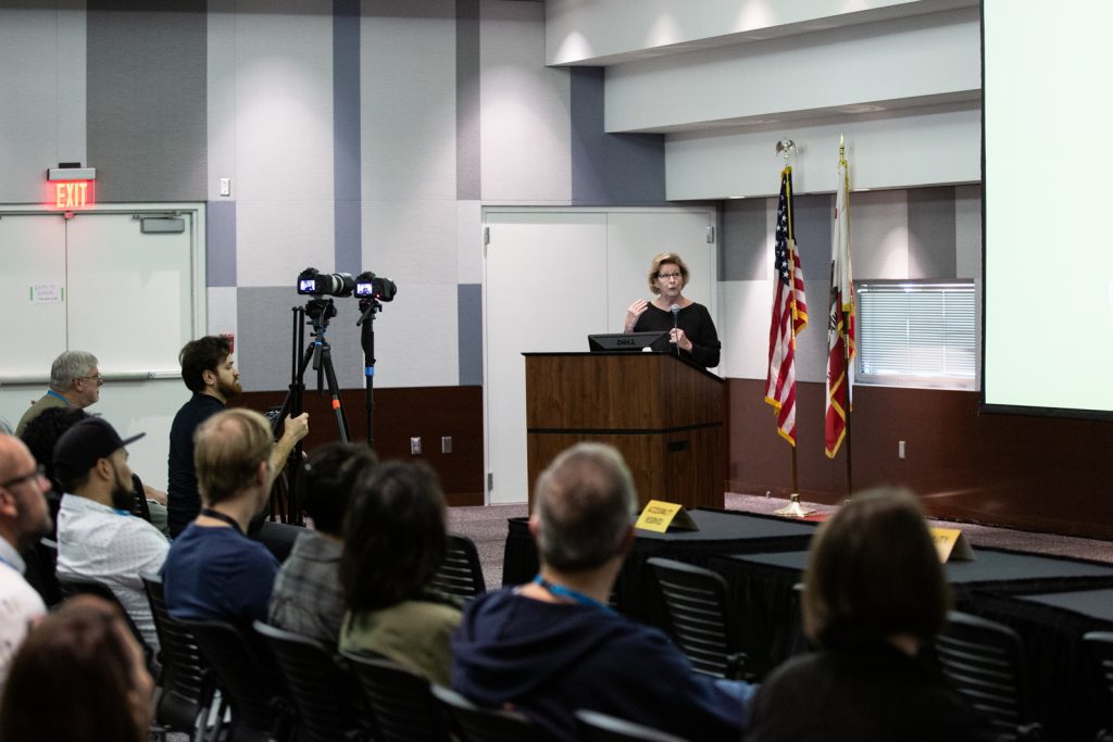 Speaker Linda Gunn speaking on a microphone