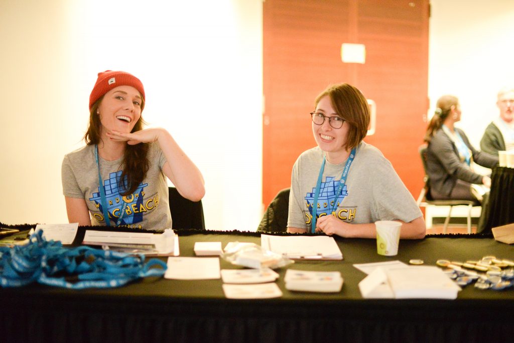 Two Volunteers sitting at Check-In and Registration