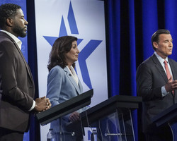 New York Public Advocate Jumaane Williams, left, New York Governor Kathy Hochul, center, listen as Rep. Tom Suozzi speaks.