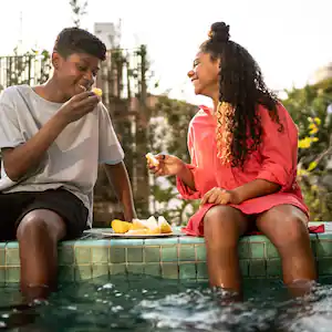  Friends eating fruit by the pool